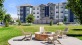 a firepit with chairs and a building in the backgrounnd