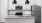 a kitchen with white cabinets a stovetop a fridge and a sink