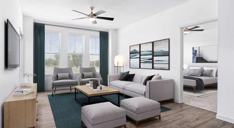 a living room with a couch and a table and tv and windows