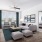 a living room with a couch and a table and tv and windows