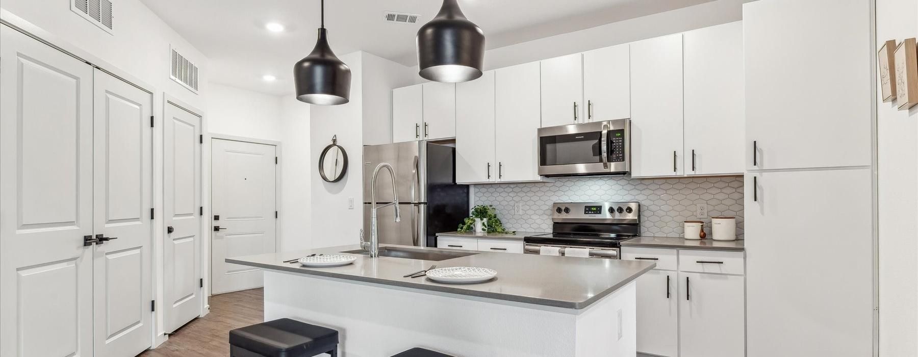 a kitchen with white cabinets